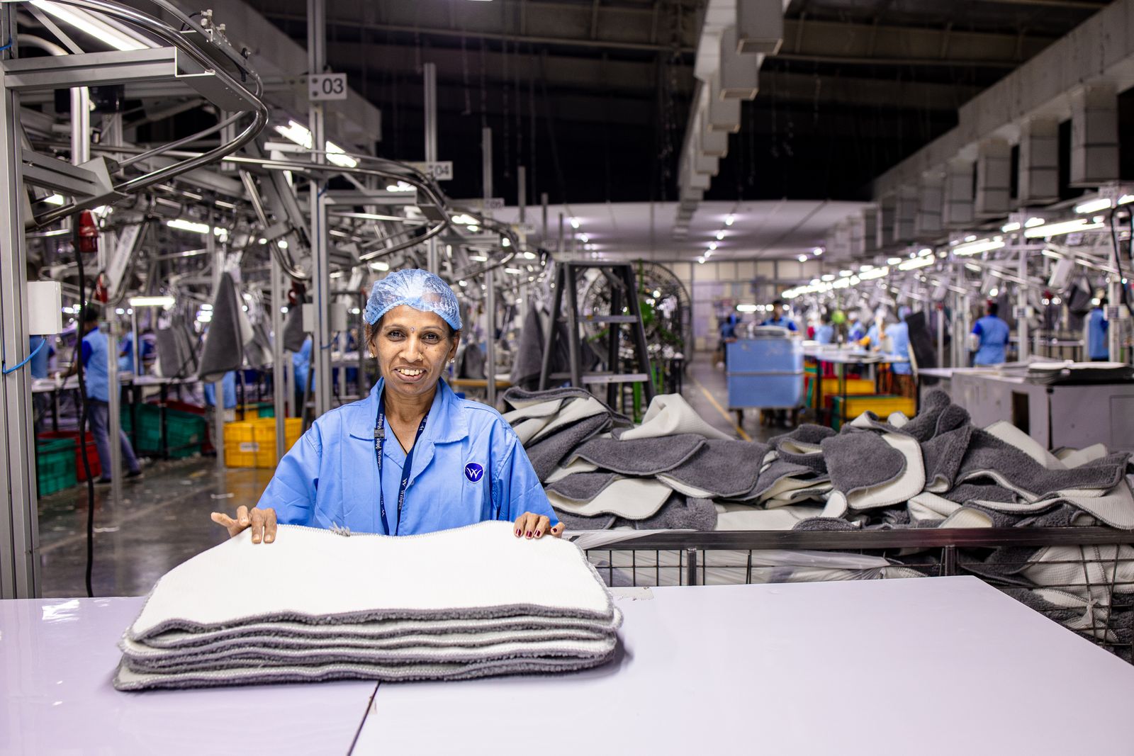 Engineer reviewing plans on a factory floor for a B2B commerce project