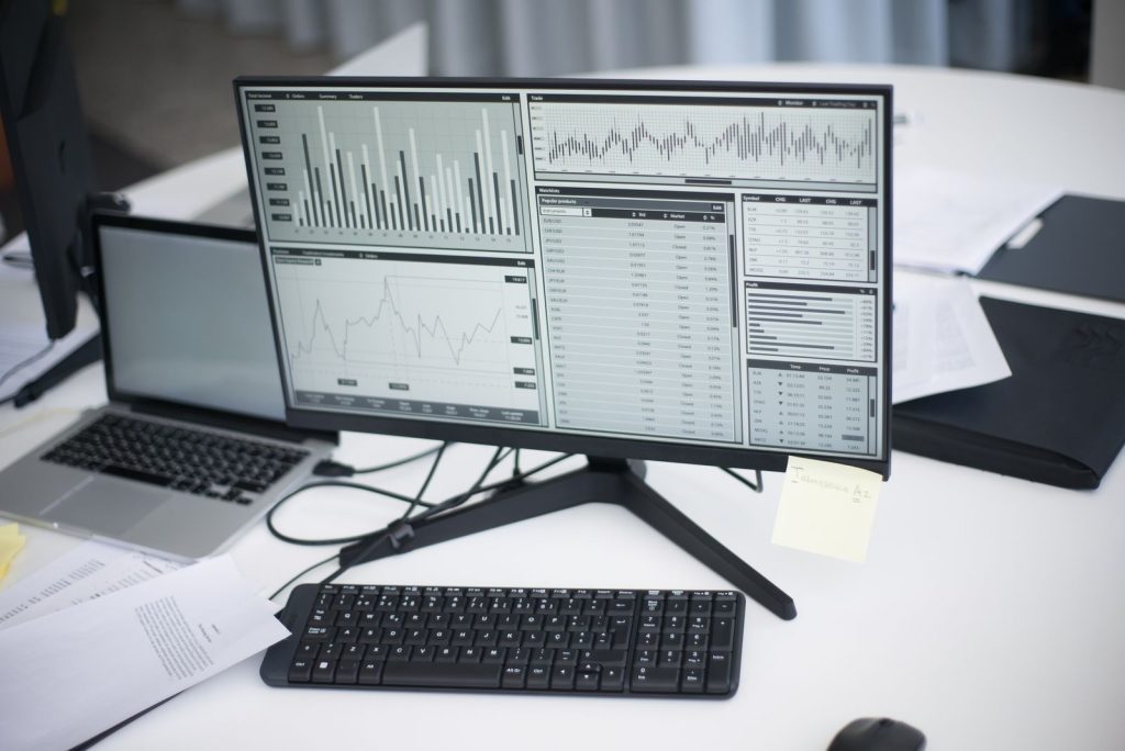 Multiple monitors showing live commerce performance dashboards