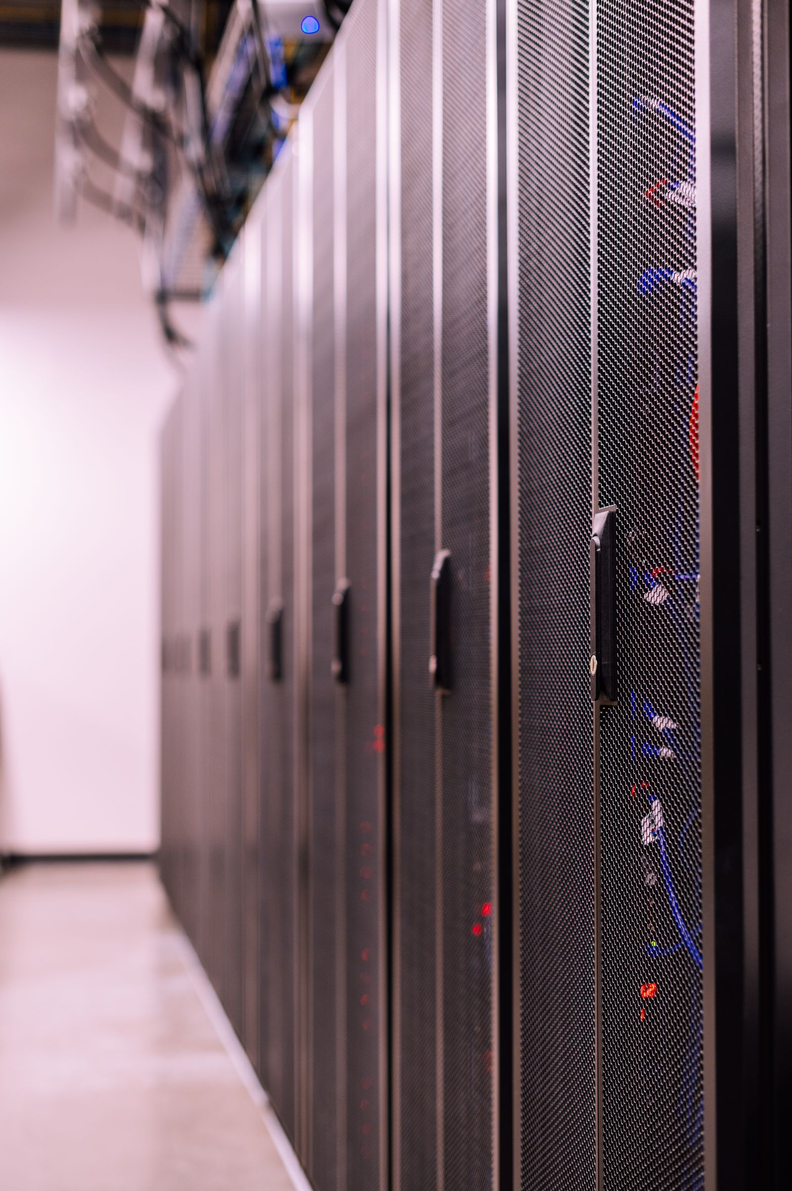 Site reliability engineer working inside a data centre aisle
