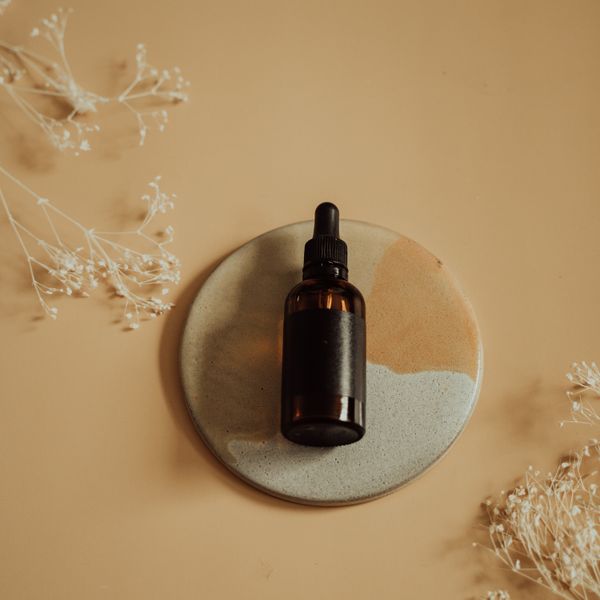 Amber glass dropper bottle of care oil